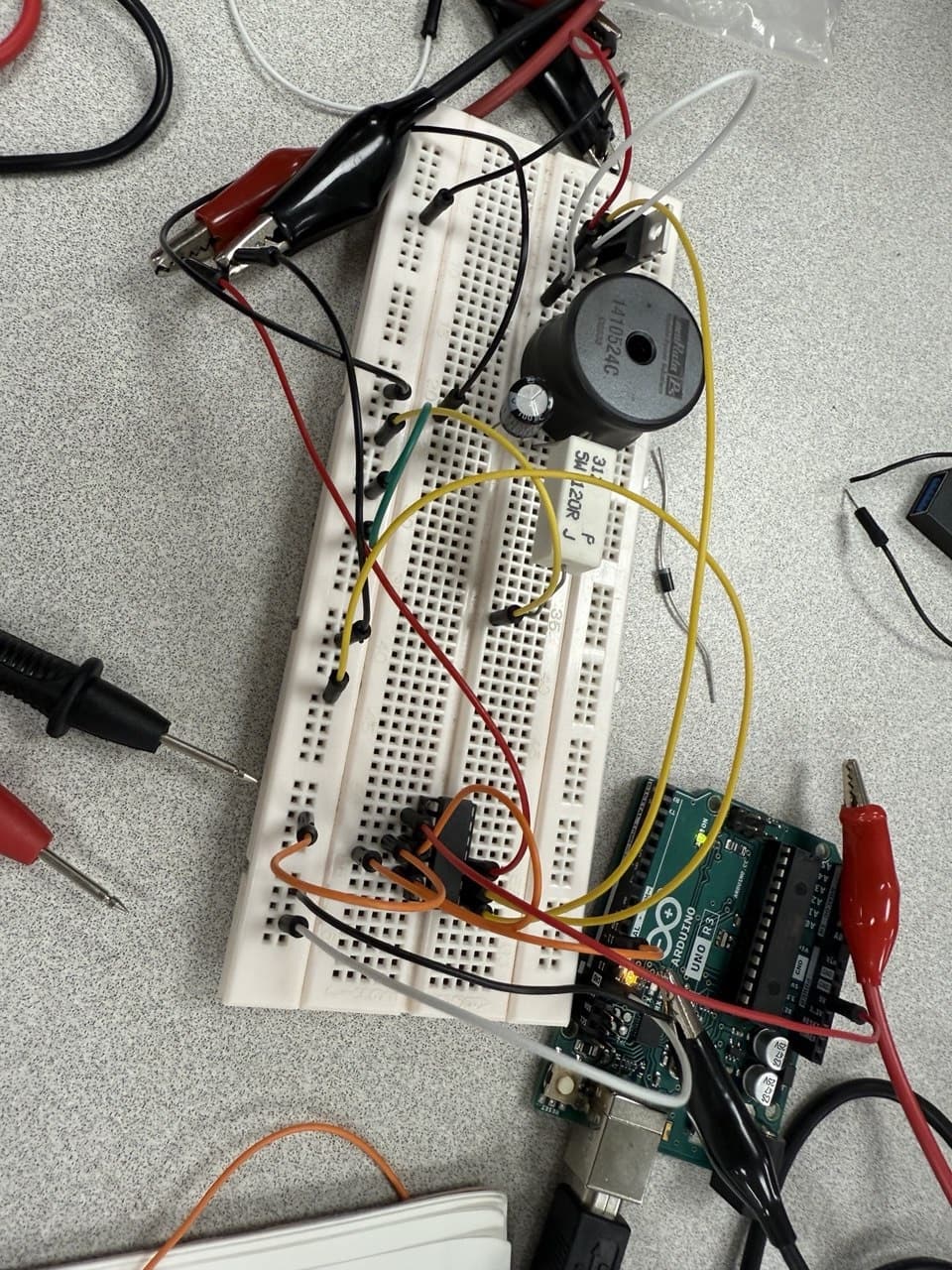 A breadboard circuit wired to an Arduino board during an engineering lab session
